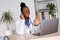African female doctor talk to patient by telemedicine online webcam video call.