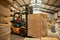 African female forklift operator moving boxes around a warehouse