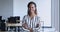 African female office employee posing in modern coworking space