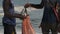 An African Fisherman with Bunch of Fish Sells Catch to a Local Man, Zanzibar