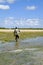 African fisherman leaving the beach with his fishing net