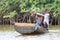 African fishermen rowing in mangroves