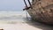 African Fishing Boat Stranded in the Sand on the Beach at Low Tide, Zanzibar