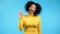 African friendly woman waving hand - hello. Greeting, say Hi to camera. Beautiful young girl on blue studio background