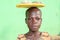 African girl carying stones on her head