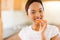 African girl eating tomato