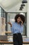 African girl enjoying a positive smartphone conversation with a friend discussing details of a startup project