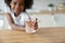 African girl holds out hand glass of water closeup image