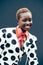 African girl laughing. Authentic smile. Girl with dotted fashionable outfit.