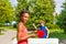African girl playing ping pong with boy outside