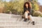 African girl sitting on the staircase outdoors