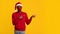 African Guy In Protective Face Mask And Christmas Santa Hat Pointing Aside