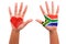 African hands with a painted heart and south african flag, i love south africa concept