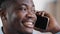 African happy confident male businessman analyst manager smiling american guy salesman speak by mobile cellphone with