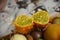 African horned cucumber, exotic fruit cut in two halves on the plate with other fruits on the light background