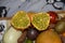 African horned cucumber, exotic fruit cut in two halves on the plate with other fruits on the light background