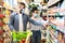 African Husband And Wife In Masks Shopping Groceries In Supermarket