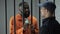 African imprisoned criminal giving euro bills to prison guard, faulty system