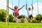 African kids playing on swing in neighborhood.