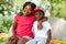 African kids sitting together on bench.