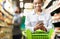 African Lady Customer Doing Grocery Shopping Using Smartphone In Supermarket