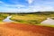 African landscape with river running through rice fields