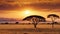 African landscape at sunset with solitary acacia tree standing tall against the backdrop of the setting sun