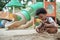 African little boy with afro hair enjoy playing sand on playground outdoors