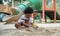 African little boy with afro hair enjoy playing sand on playground outdoors