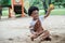 African little boy smile and enjoy playing sand with toys loader on playground outdoors in the park