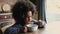 African little girl eating corn flakes with milk closeup