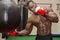 African male boxer punching ball wearing boxing