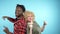 African man and caucasian woman with afro haircut is dancing. Blue background