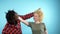 African man and caucasian woman with afro hairstyle. Blue background