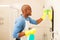 African man cleaning bathroom