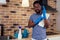 African man cleaning cooktop cooker hood at home ,Brick wall background