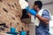 African man cleaning cooktop cooker hood at home ,Brick wall background