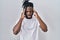 African man with dreadlocks wearing casual t shirt over white background with hand on head for pain in head because stress