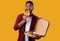 African Man Eating Pizza Smiling To Camera Over Yellow Background