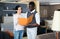 African man with his wife are choosing furniture and looking on price