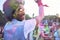 African man in holi colors dancing during music festival