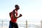 African man jogging on seaside promenade