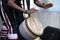 African man playing djembe drums