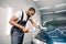 African man professional car detailing worker, polishes a blue car with a polisher and microfiber cloth. Car detailing