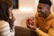 African Man Proposing Showing Engagement Ring Box To Girlfriend Indoor