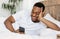 African Man With Smartphone Using Mobile App Lying In Bed