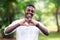 African man smiling with heart sign