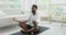 African man in sportswear doing meditation practice after yoga workout