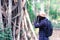 African man traveler explorer with photo camera in forest