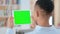 African Man Watching Tablet with Green Chroma Key Screen, Rear View